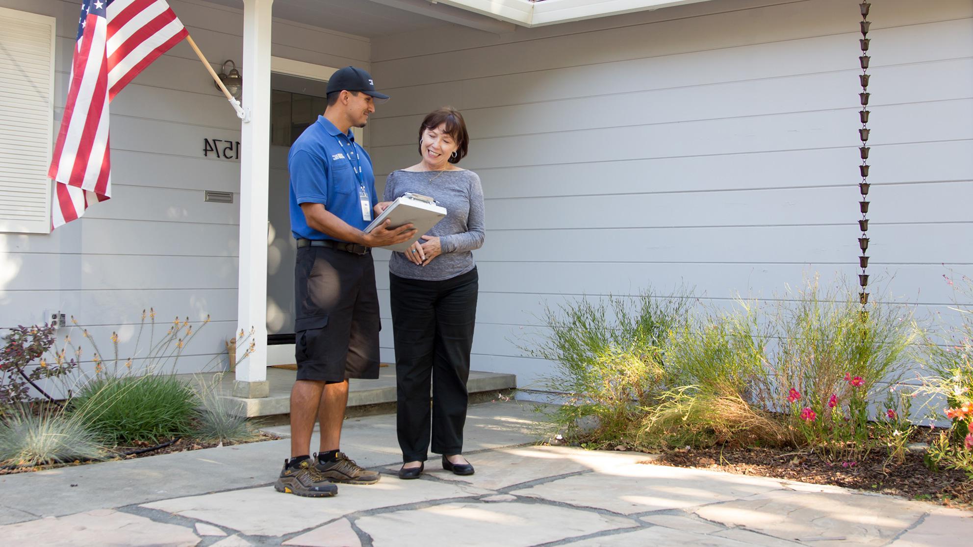 San Jose Water Worker and Customer talk outside a home